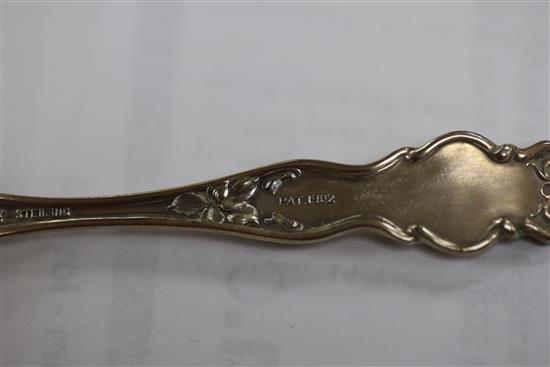 A set of twelve American sterling coffee spoons, the handles cast with scrolls, Venus and Cupid